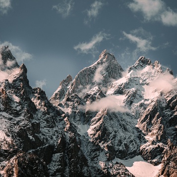 Snow-capped mountain peaks above the clouds