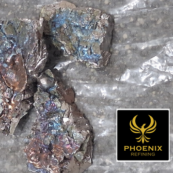 Iridescent metal scrap pieces on foil