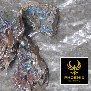 Iridescent metal scrap pieces on foil